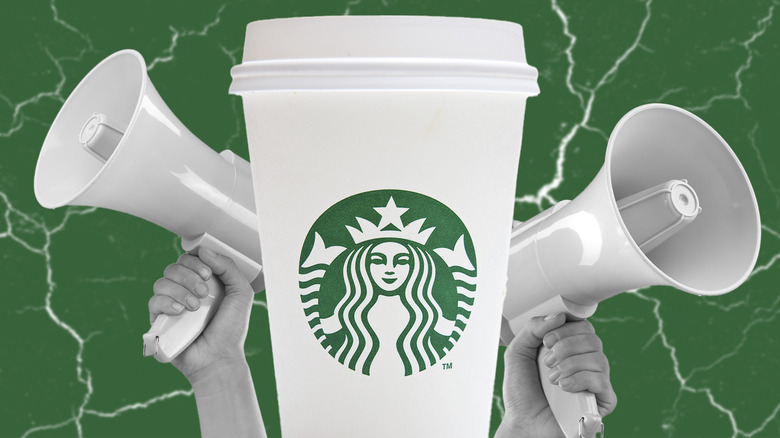 Starbucks cup next to megaphones on green background