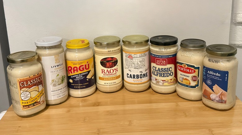 multiple types of gluten-free Alfredo sauce jars on display