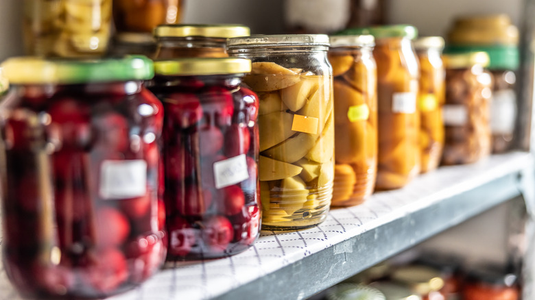 A shelf full of repurposed glass jars