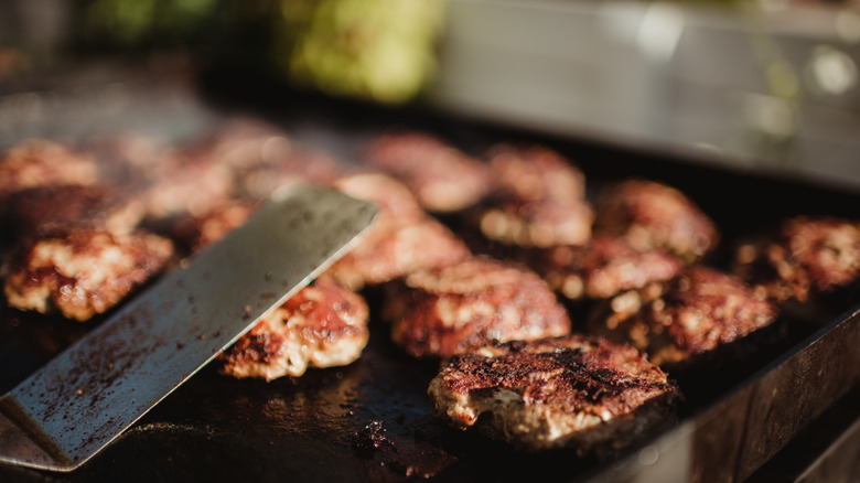 burgers cooking on a Blackstone grill