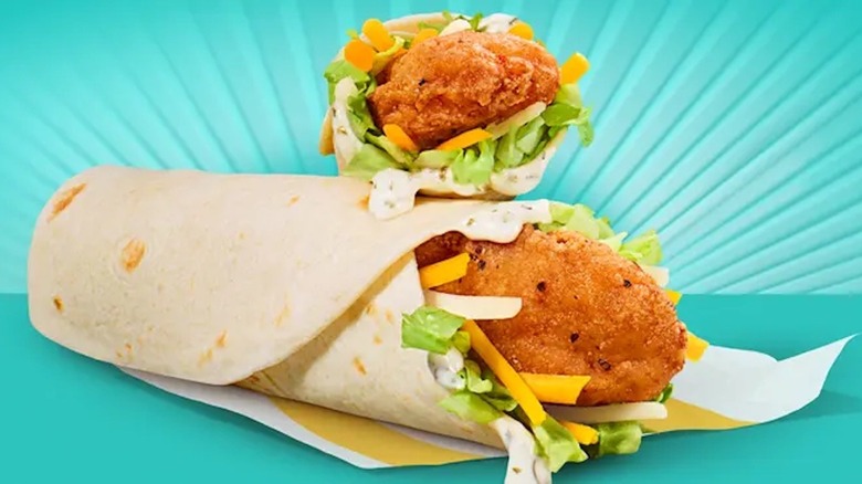 Two McDonald's chicken Snack Wraps on a teal background