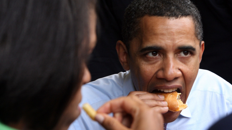 President Barack Obama eating a cheesesteak and fries alongside wife Michelle Obama