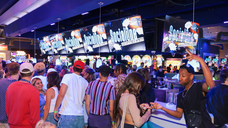 People mingle around the bar at Dave & Buster's.