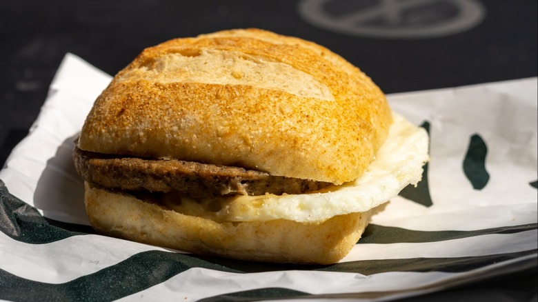 A Starbucks breakfast sandwich with egg on a branded wrapper