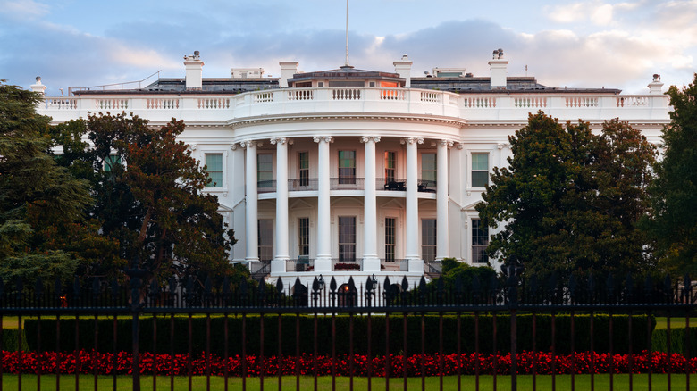 the white house under blue sky with clouds