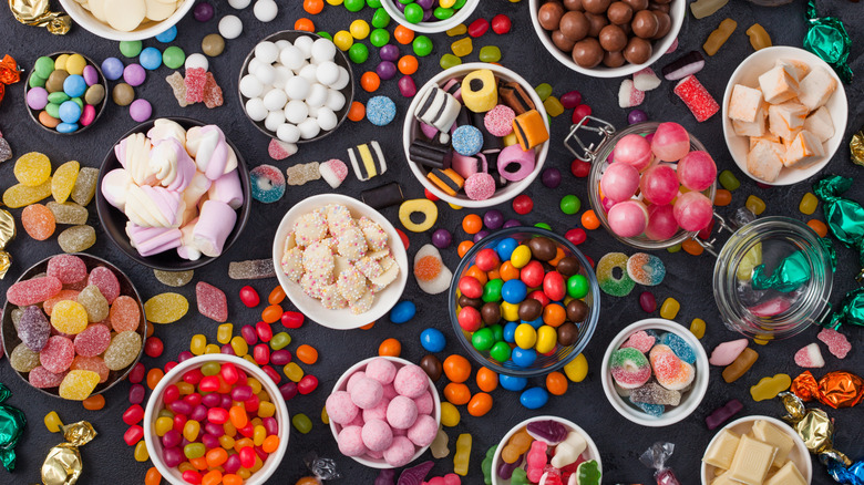 assortment of different candies in piles and bowls