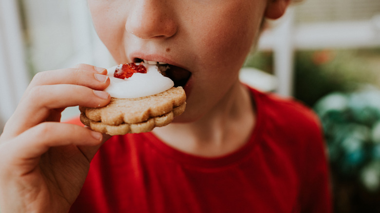 Child about to take a bite from a cookie
