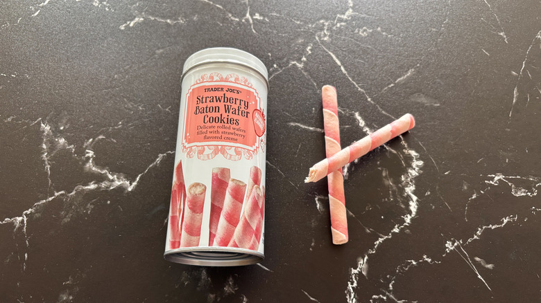 Trader Joe's strawberry baton wafer cookie tin next to wafer cookies